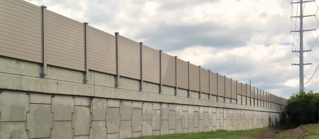 Structure-mounted-sound-wall-on-retaining-wall
