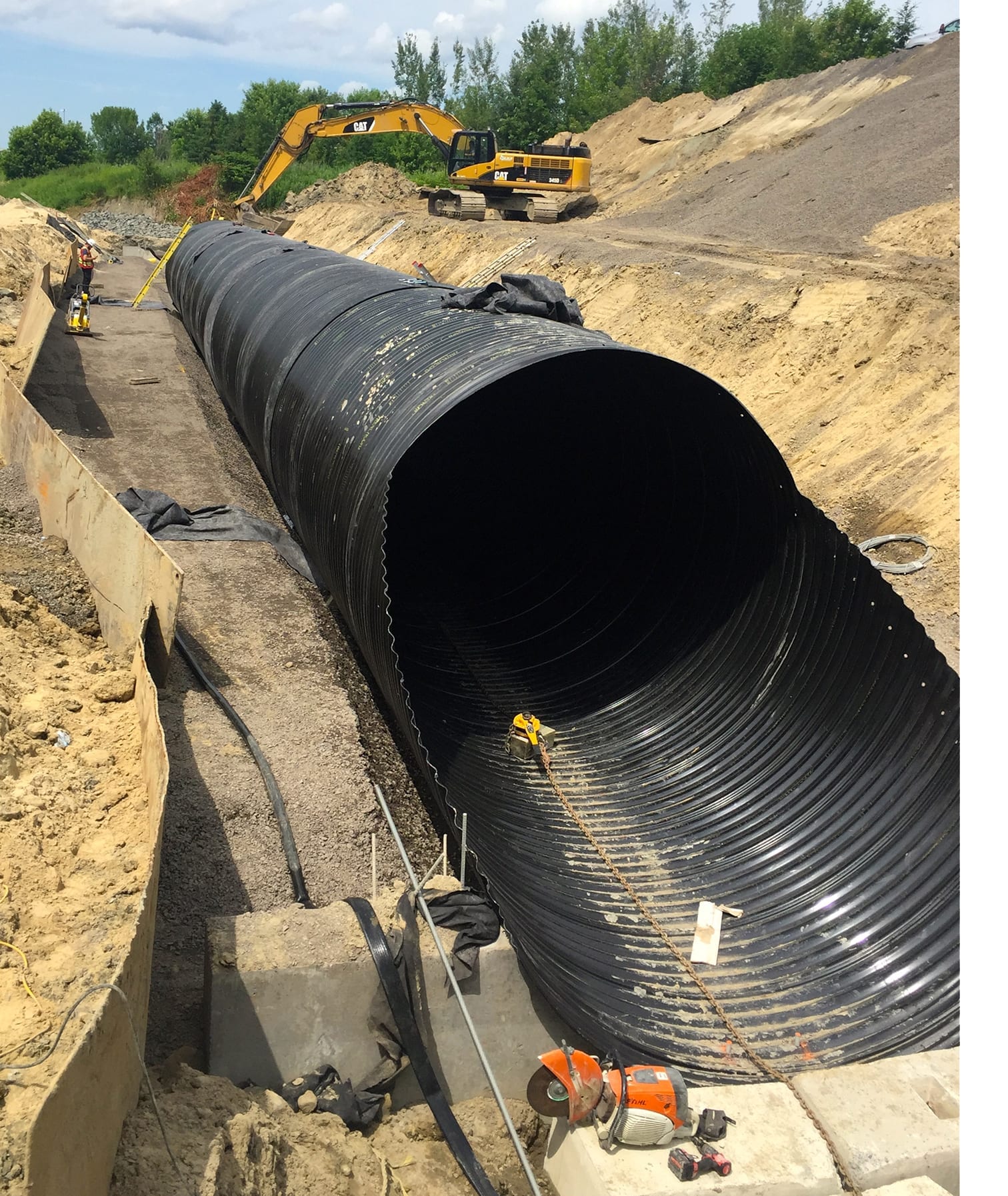 Bevelled end view of Polymer-Coated Corrugated Steel Pipe culvert installation