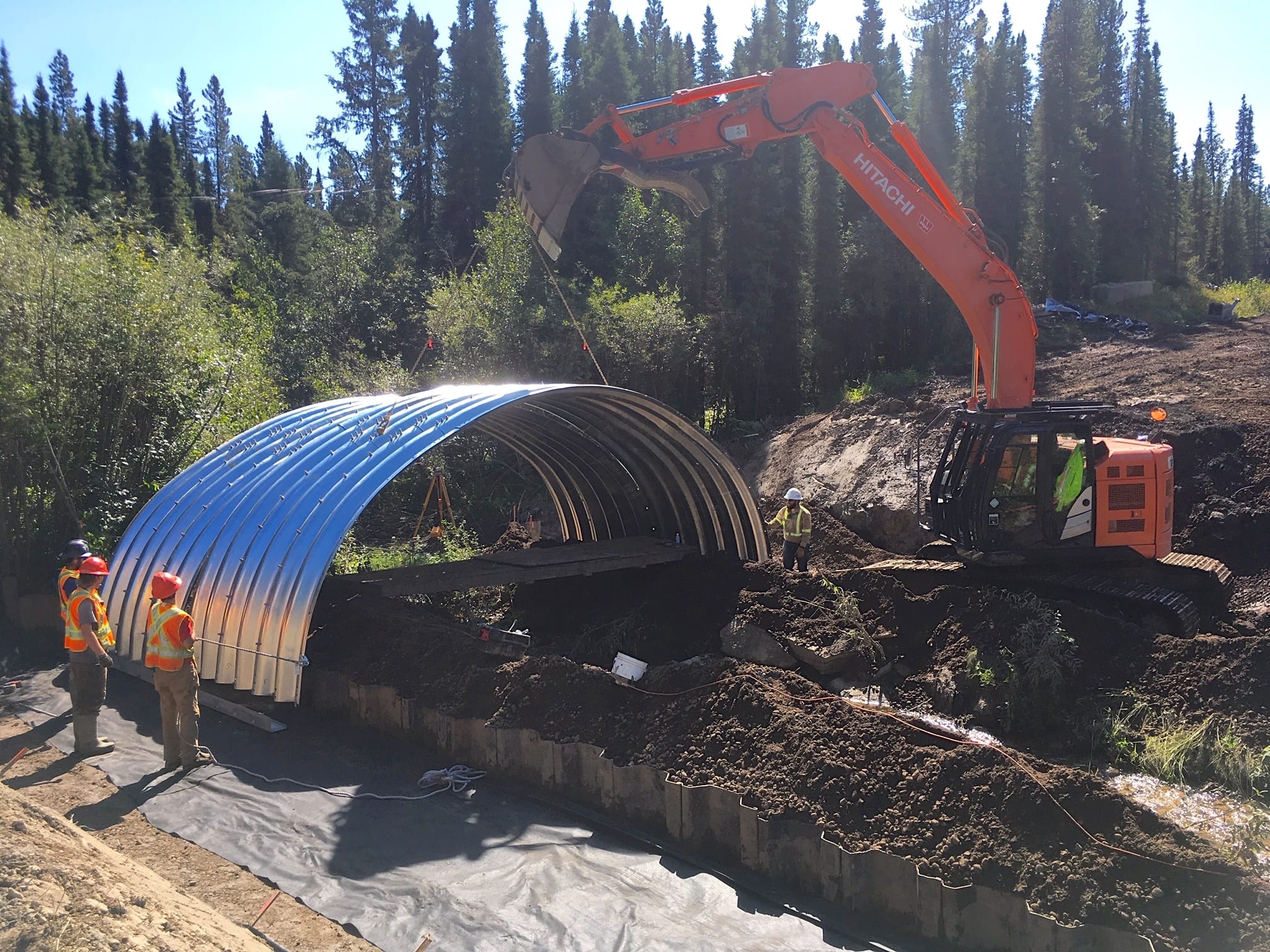 Wide view of AIL GRS Bridge section being installed on resource road