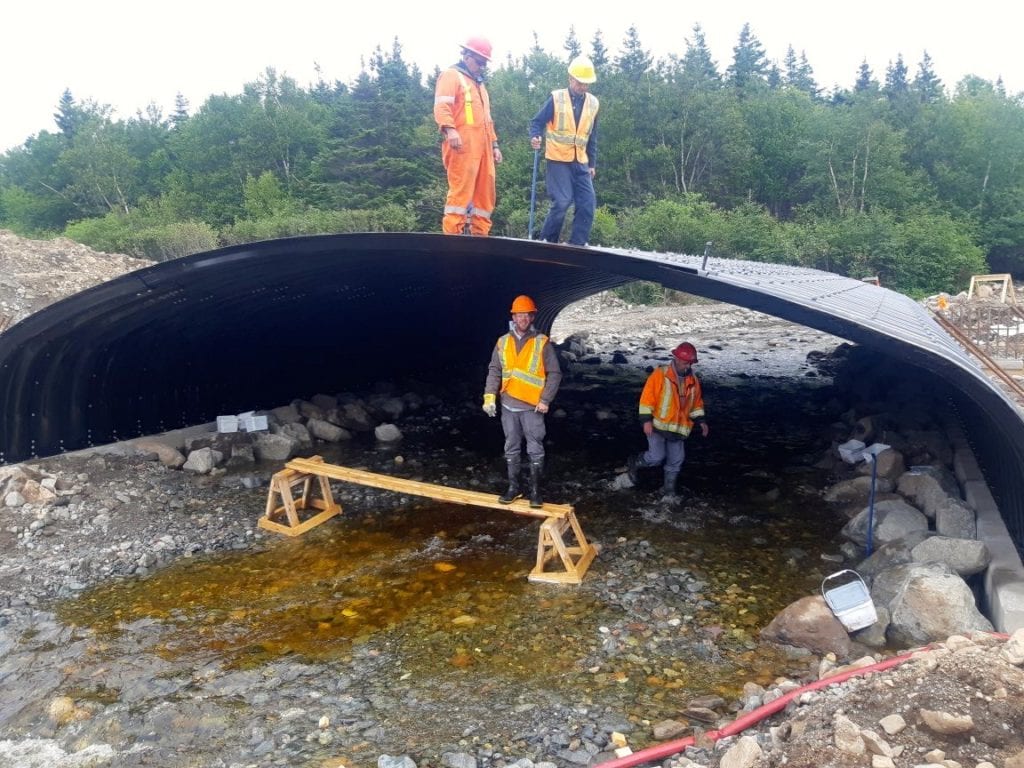 Crew completes box culvert assembly over active streambed