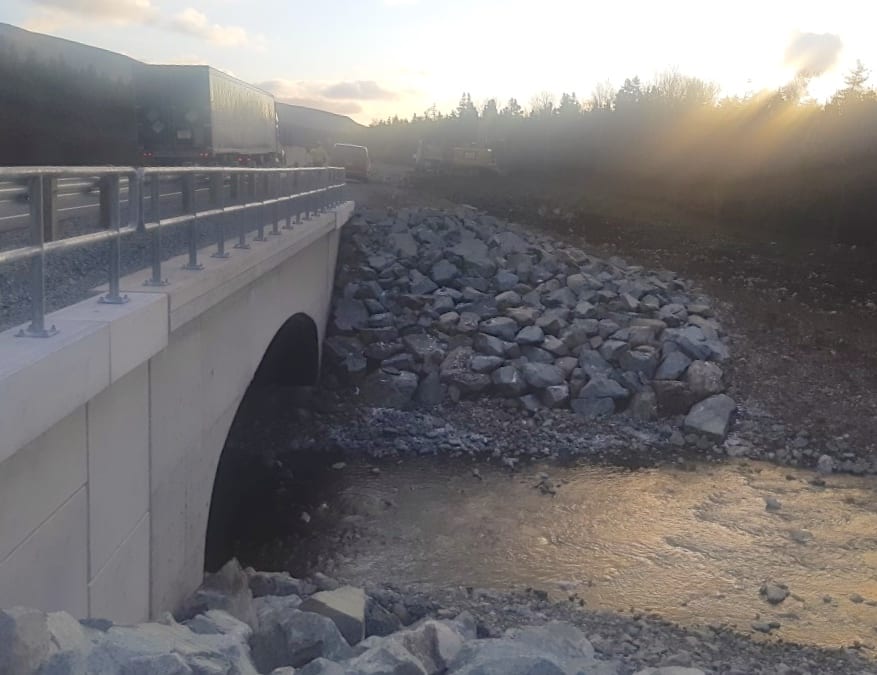 Truck on completed buried metal bridge stream crossing