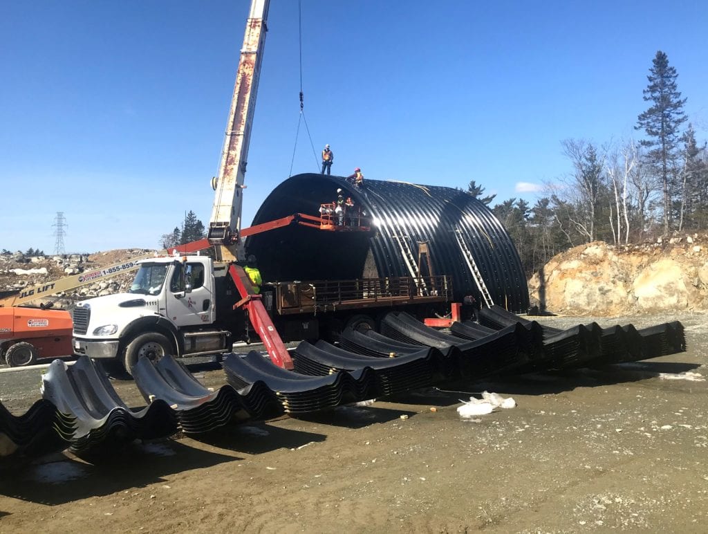 Polymer-coated structural plate sections at job site