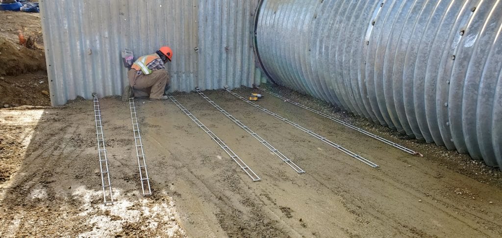 Grid-Strip Soil Reinforcement attaches to back of steel headwall