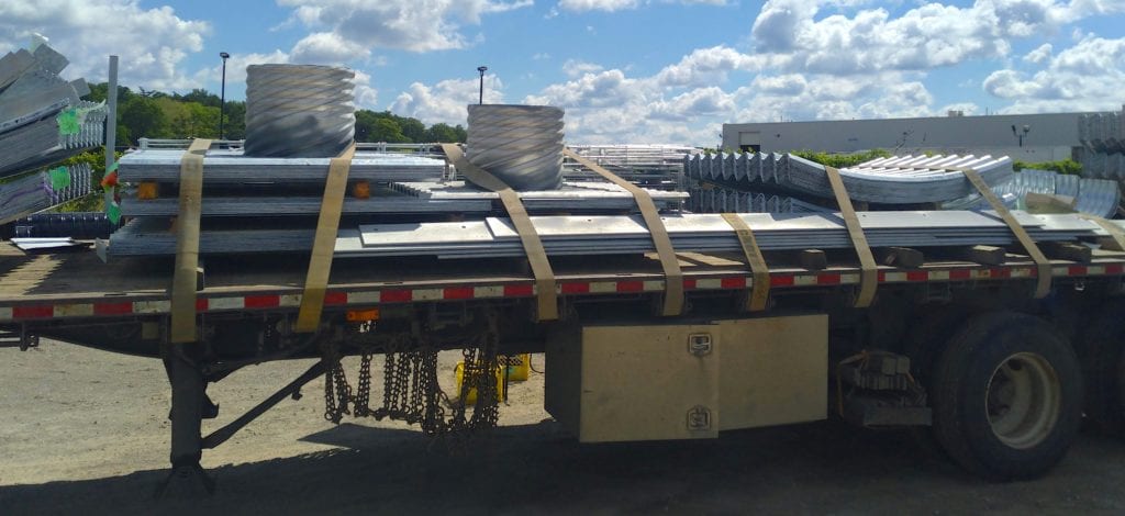 Bolt-A-Plate culvert and headwall components on flatbed trailer