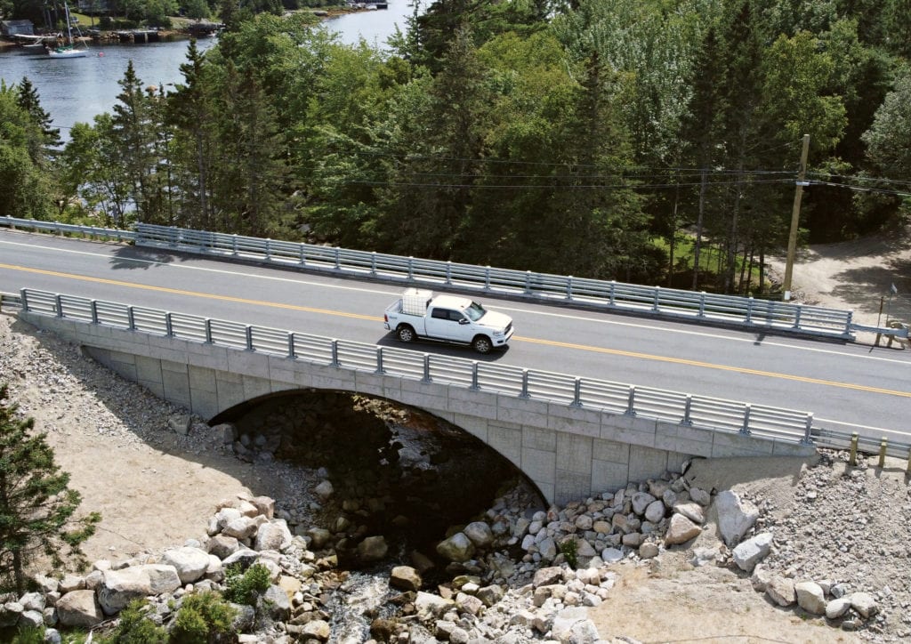 Buried metal bridge with MSE precast panel headwalls