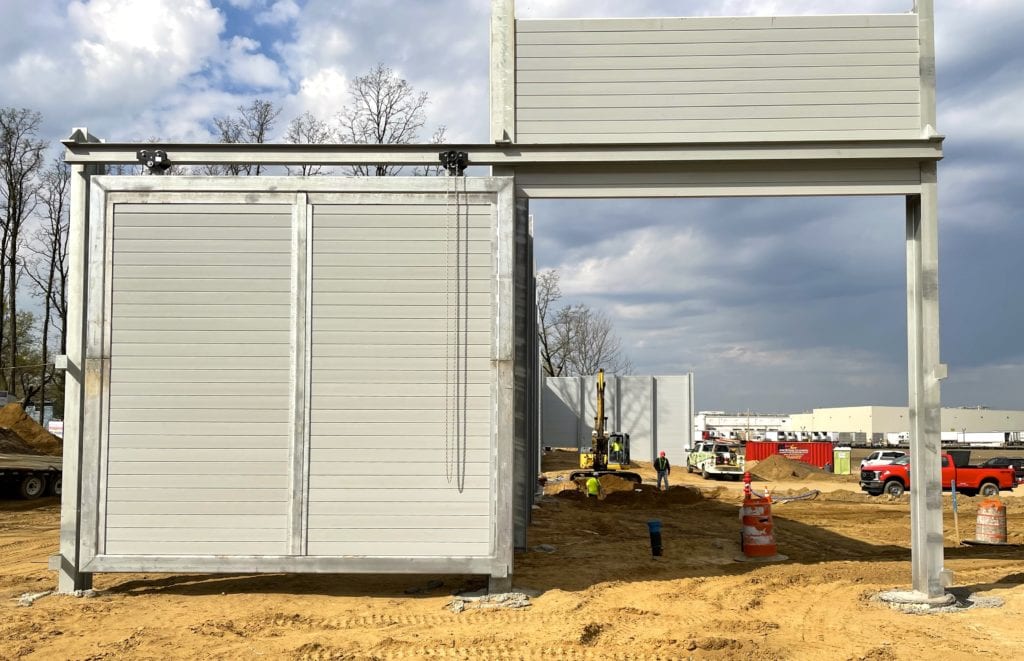 End view of sound barrier wall with large sliding door open