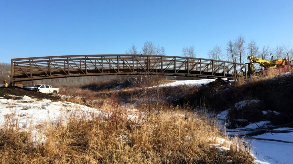 Wide view of prefabricated golf course bridge in position