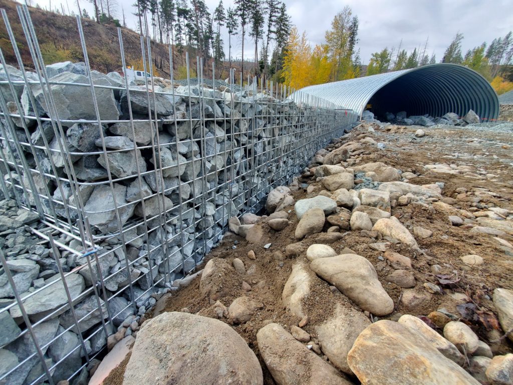 Angled view of wire wall headwalls and buried metal bridge