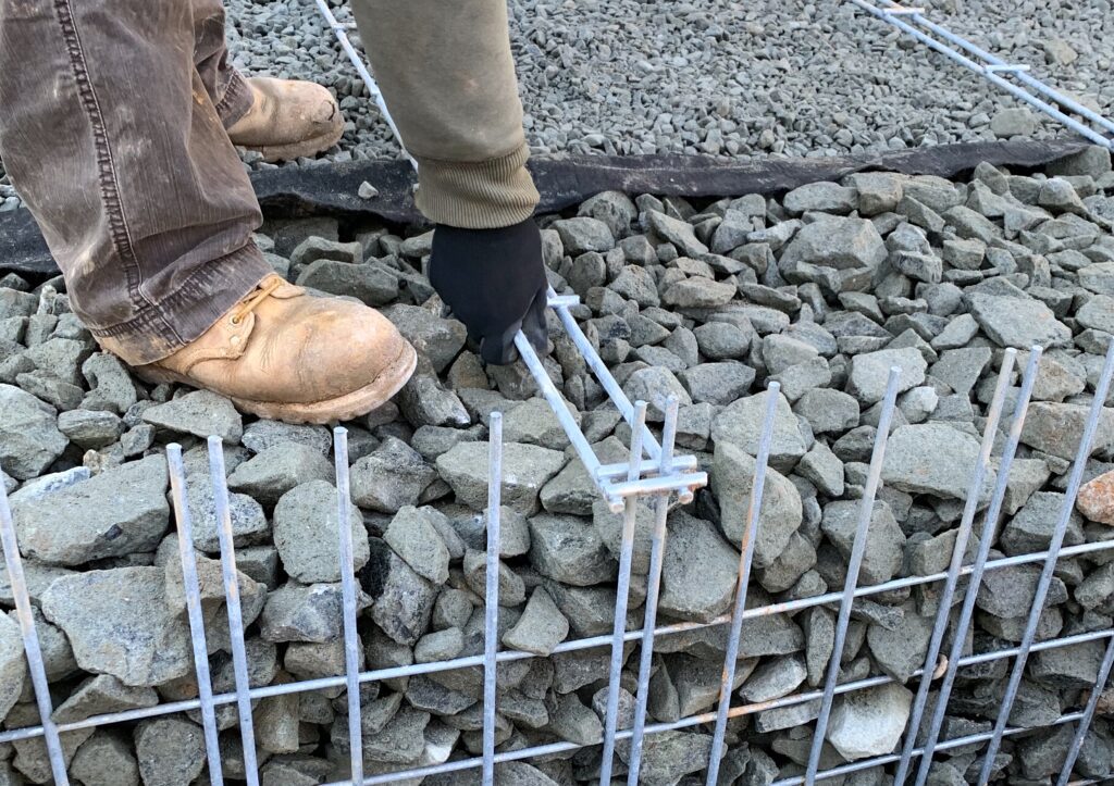 Track-Strip soil reinforcement system for wire mesh wall retaining walls