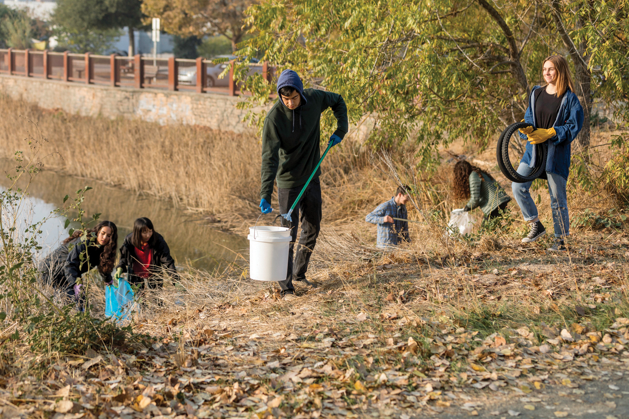 teens engaged in community service picking up trash