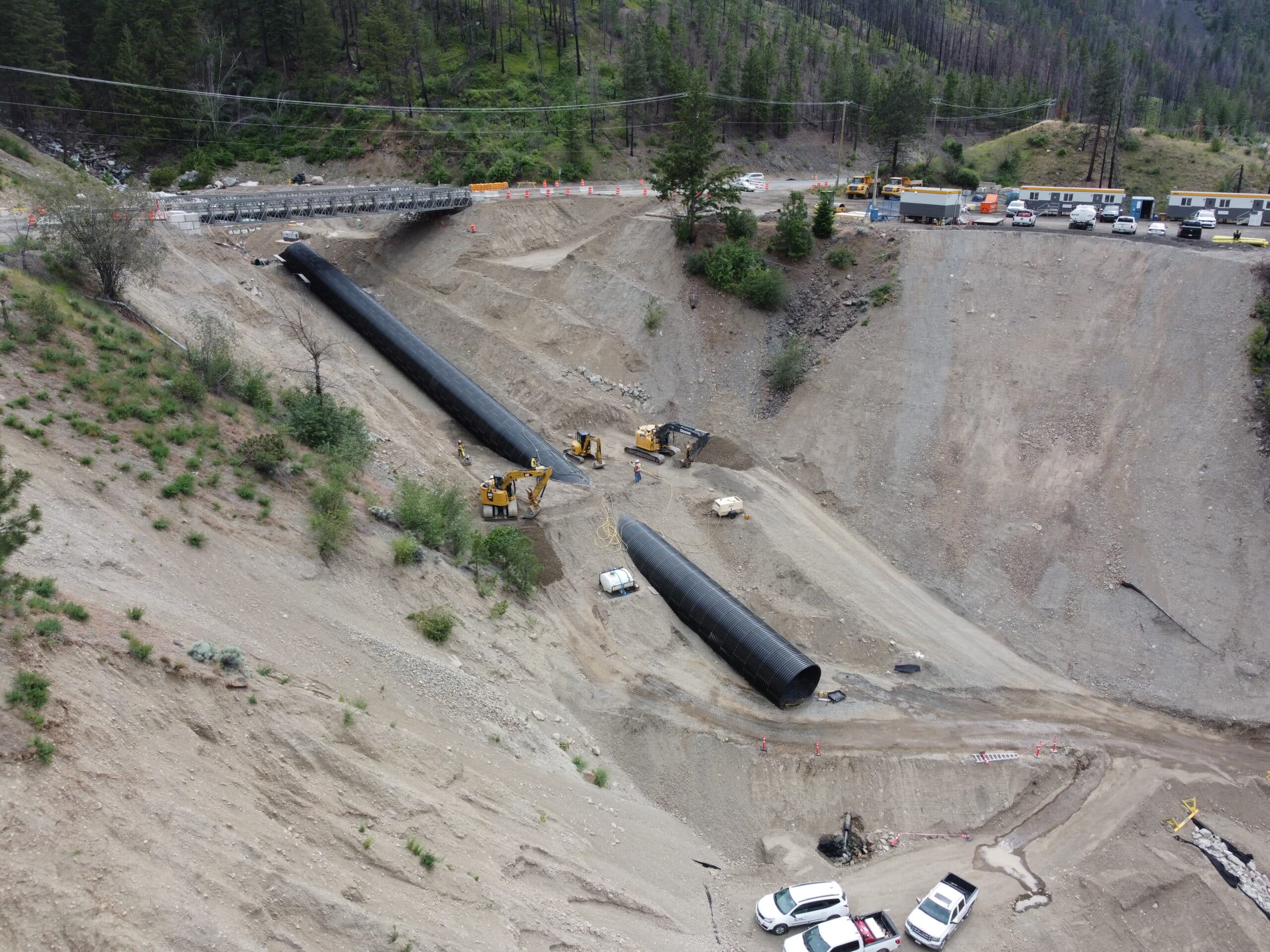 Aerial view of installation of oversized AIL-Bolt-A-Plate Structural Steel Plate Round at 24% grade
