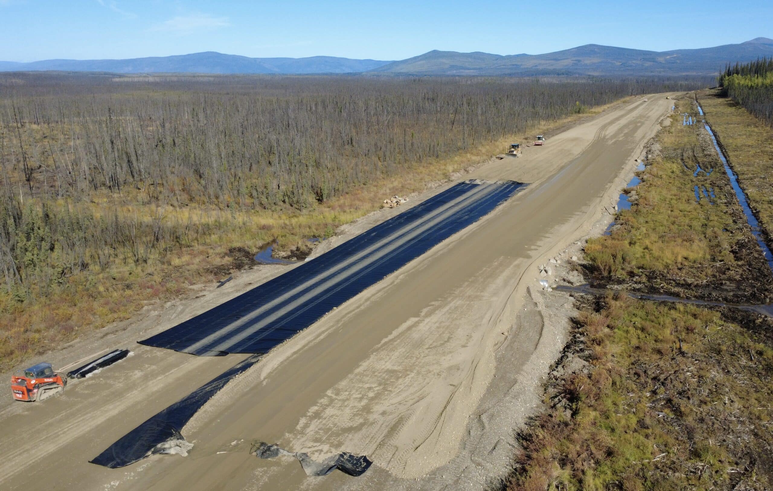 Angled aerial view of high-performance woven geotextile on highway embankment